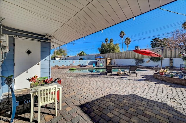 view of patio featuring a fenced in pool and a fenced backyard