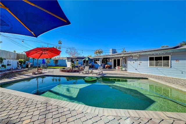 view of swimming pool featuring a fenced in pool, a patio, and a fenced backyard