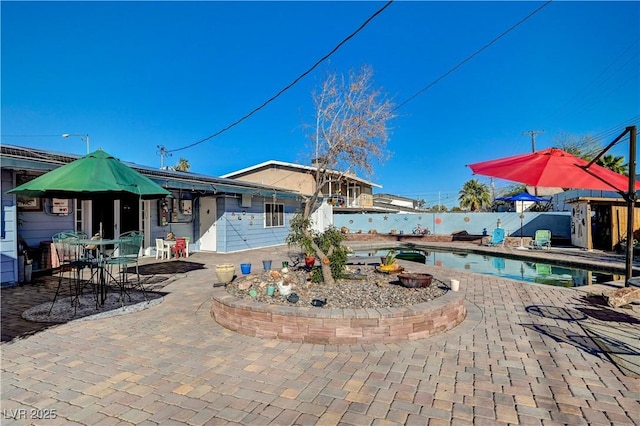 view of pool featuring a fenced in pool, fence, and a patio area