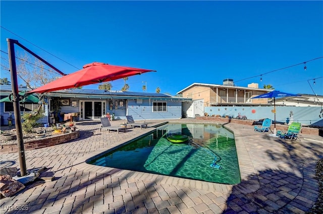 view of swimming pool with a patio area, a fenced in pool, and a fenced backyard