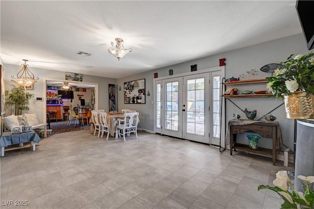 dining area with visible vents and french doors