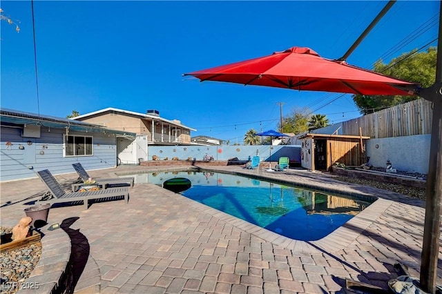 view of swimming pool with a patio area, a fenced in pool, and a fenced backyard