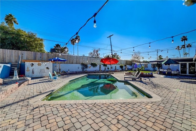 view of pool with a fenced in pool, a patio, and a fenced backyard