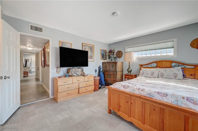 bedroom with baseboards and visible vents