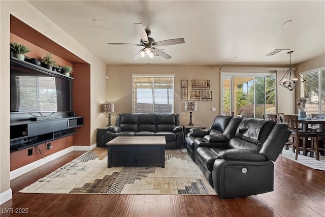 living area featuring wood finished floors, visible vents, and baseboards