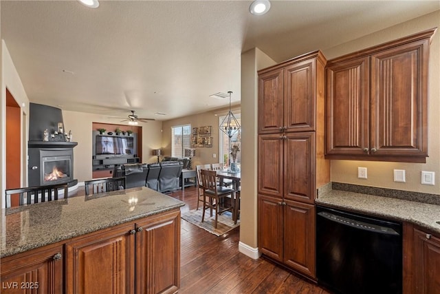 kitchen featuring light stone counters, dark wood finished floors, a glass covered fireplace, open floor plan, and dishwasher