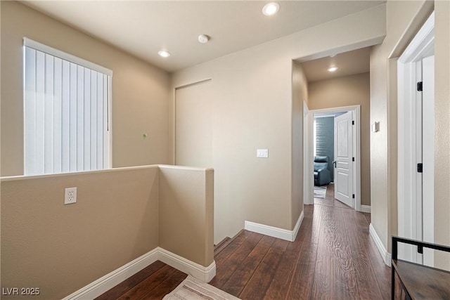 hall featuring recessed lighting, baseboards, an upstairs landing, and hardwood / wood-style flooring