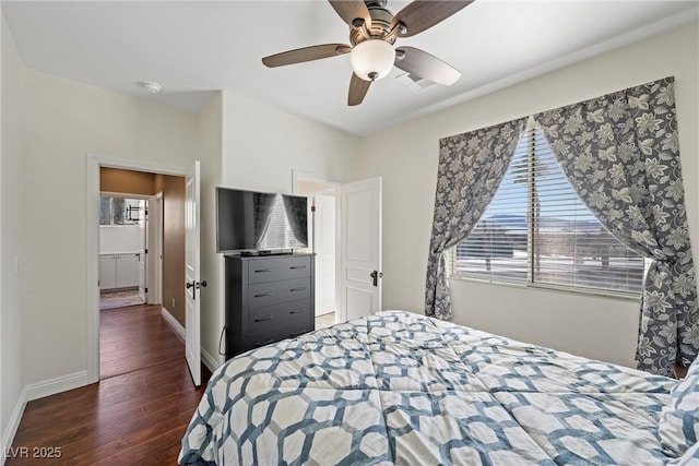 bedroom with a ceiling fan, visible vents, baseboards, and wood finished floors