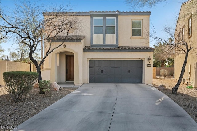 view of front facade with a garage, driveway, fence, and stucco siding