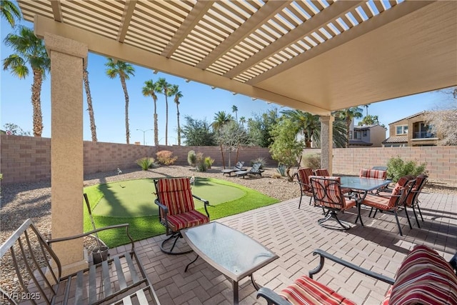 view of patio with outdoor dining space, a fenced backyard, and a pergola