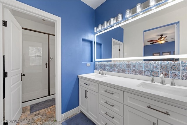 full bathroom with tasteful backsplash, a stall shower, a sink, and double vanity