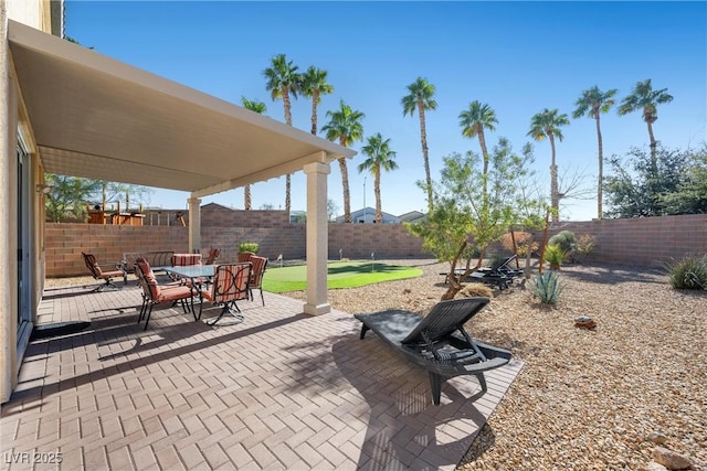 view of patio with outdoor dining area and a fenced backyard