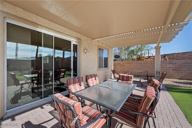 view of patio with outdoor dining area, fence, and a pergola