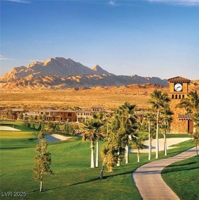 view of home's community with a mountain view and a yard