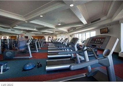 workout area featuring ornamental molding and coffered ceiling