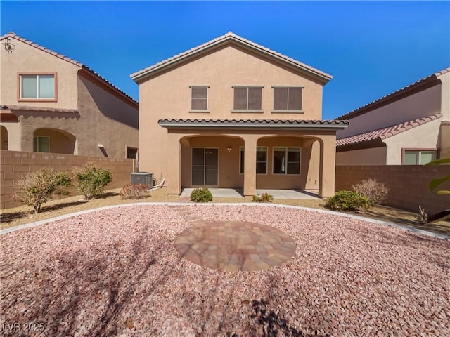 back of house featuring a patio area, fence, and stucco siding