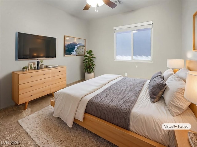 carpeted bedroom featuring visible vents and a ceiling fan