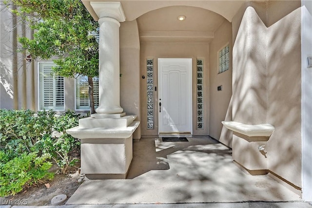 doorway to property featuring stucco siding