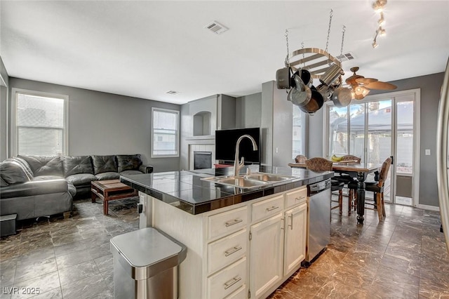 kitchen with open floor plan, a sink, visible vents, and dishwasher