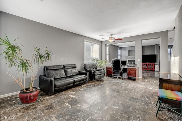 living room with marble finish floor, ceiling fan, and baseboards