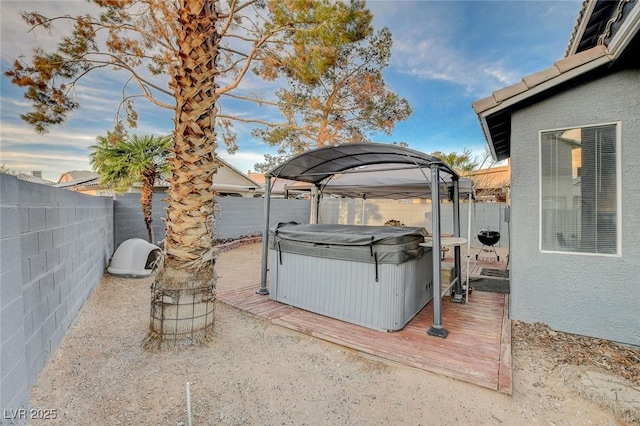 view of yard with a fenced backyard and a hot tub