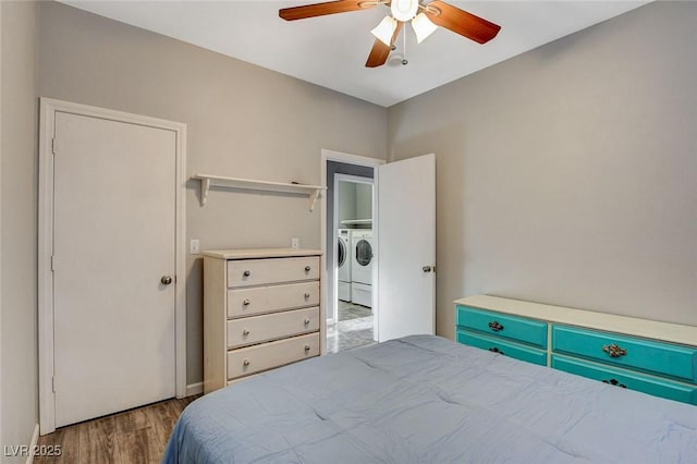 bedroom with wood finished floors, washing machine and dryer, and a ceiling fan