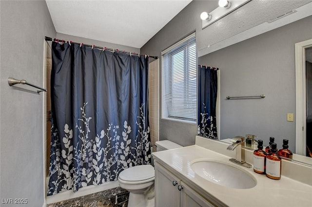 bathroom featuring a shower with curtain, vanity, and toilet