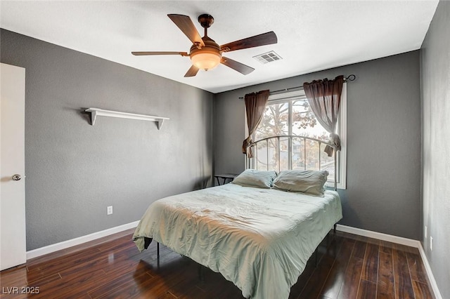 bedroom with hardwood / wood-style flooring, baseboards, and visible vents