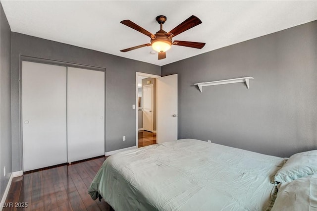 bedroom with baseboards, a closet, a ceiling fan, and wood finished floors