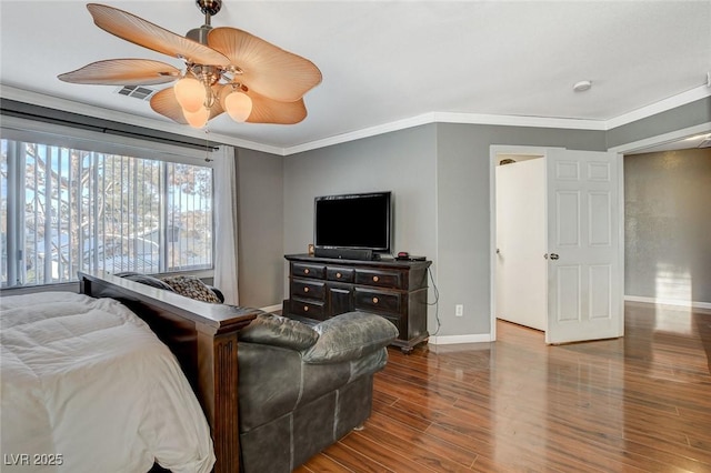 bedroom with baseboards, visible vents, a ceiling fan, wood finished floors, and crown molding