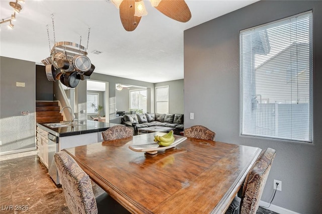 dining area with a ceiling fan, visible vents, baseboards, and stairs