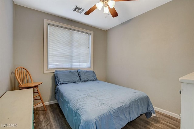 bedroom featuring a ceiling fan, baseboards, visible vents, and wood finished floors