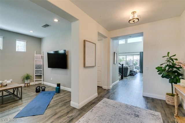 workout area featuring recessed lighting, wood finished floors, visible vents, and baseboards