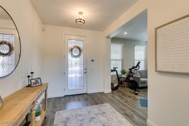 foyer featuring baseboards and wood finished floors