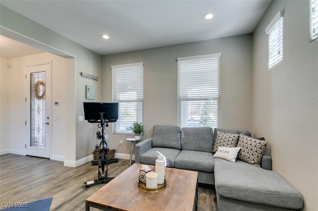 living room with baseboards, wood finished floors, and recessed lighting