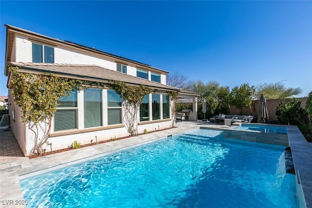 rear view of property with a fenced in pool, stucco siding, outdoor lounge area, a patio area, and fence