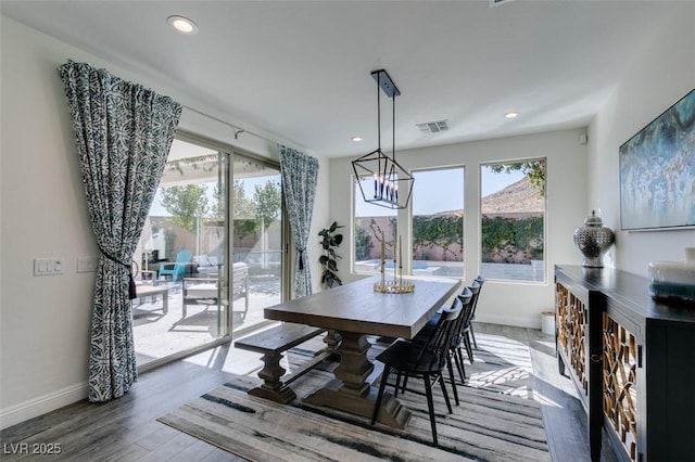 dining space with recessed lighting, visible vents, plenty of natural light, and wood finished floors