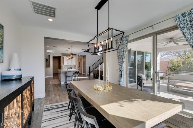 dining area with recessed lighting, visible vents, stairway, wood finished floors, and ceiling fan with notable chandelier