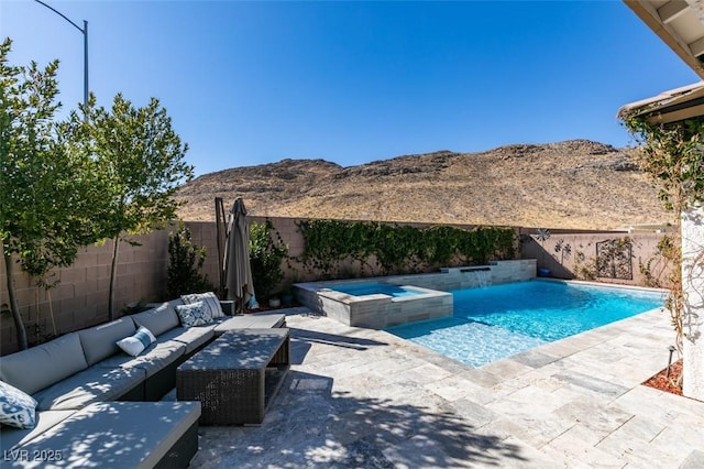 view of pool with a fenced backyard, a mountain view, and a patio