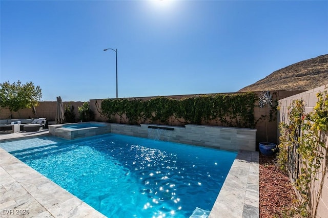 view of swimming pool featuring a patio area, outdoor lounge area, a fenced backyard, and a pool with connected hot tub