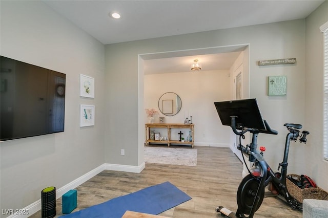 exercise room with recessed lighting, baseboards, and wood finished floors