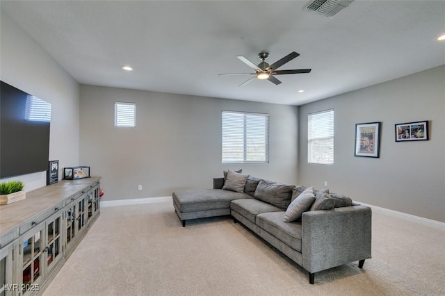 living room featuring recessed lighting, visible vents, a ceiling fan, light carpet, and baseboards