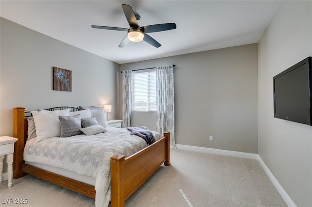 bedroom with light carpet, ceiling fan, and baseboards