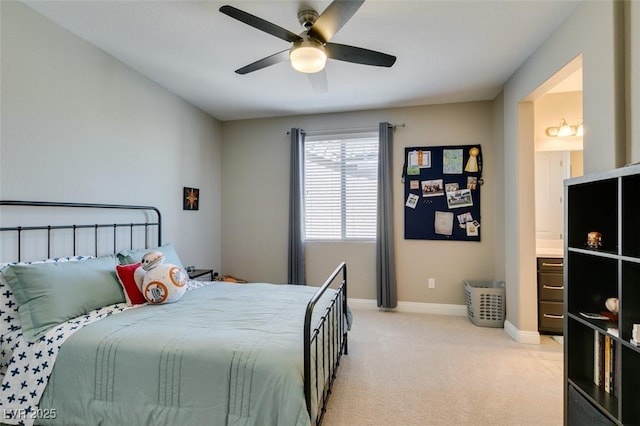 bedroom featuring light colored carpet, ceiling fan, and baseboards