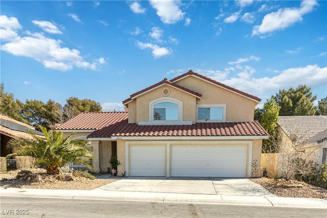 mediterranean / spanish-style house with driveway, stucco siding, a garage, and a tiled roof