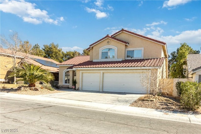 mediterranean / spanish-style house featuring concrete driveway, a tiled roof, and stucco siding