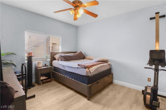 bedroom featuring ceiling fan, baseboards, and wood finished floors