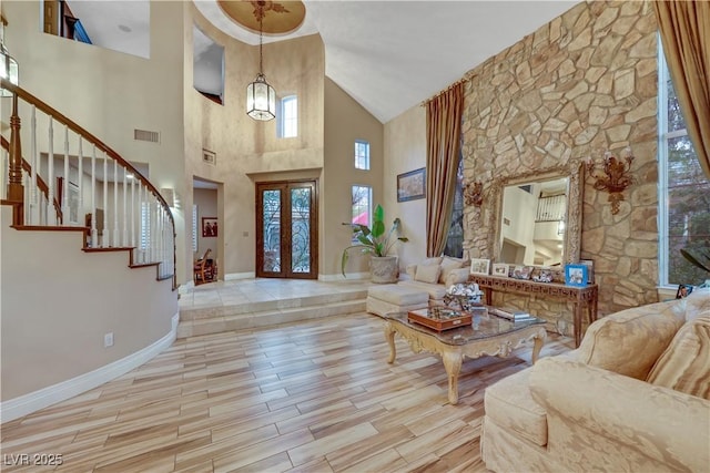 foyer with french doors, visible vents, stairway, wood finished floors, and baseboards