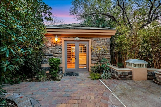 outdoor structure at dusk with french doors