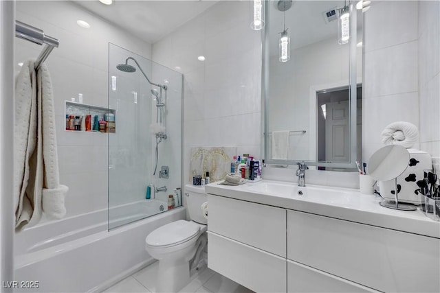 full bath featuring toilet, enclosed tub / shower combo, tile patterned flooring, vanity, and tile walls